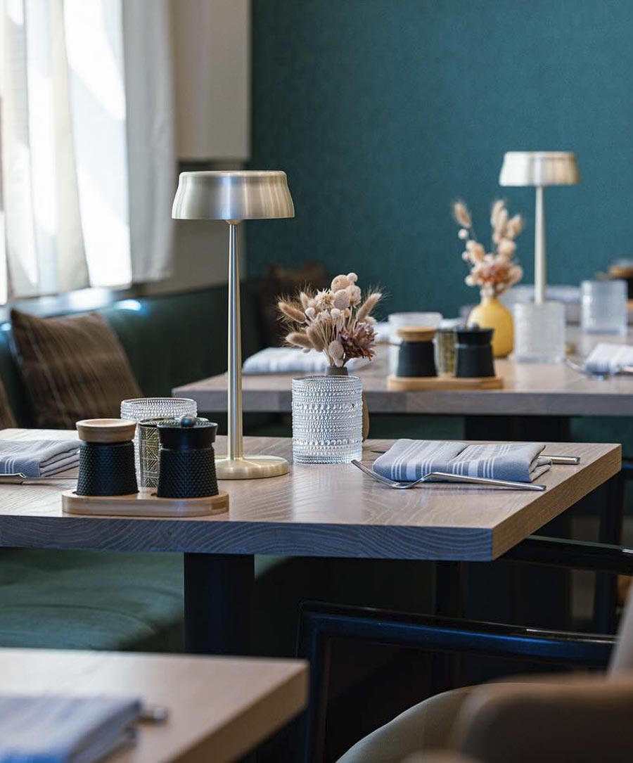 Photograph showing a placesetting at the restaurant, table at the lake.